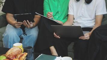 Three people sitting on a couch with laptops video