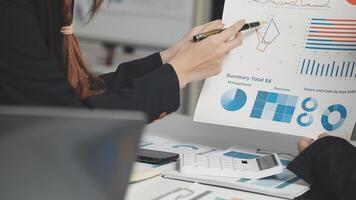 Business people working on a presentation with graphs and charts video