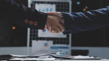 Two business people shaking hands over a desk video