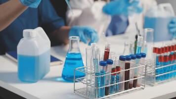 A group of people in lab coats are working on a project video