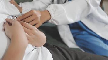 A doctor is checking the heart of a patient video