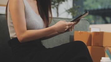 A woman sitting on a couch with a tablet video