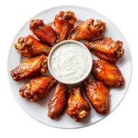 Crispy buffalo chicken wings arranged in a circular pattern on a plate with a creamy dipping sauce in the center png