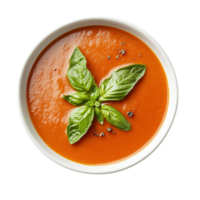 Bowl of tomato soup with a smooth texture is garnished with basil leaves and black sesame seeds png