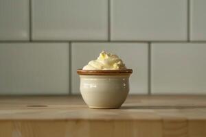 Small bowl of whipped butter sitting on wooden table in kitchen photo