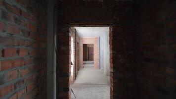 Brick corridor under construction in an unfinished building, Interior view of a brick-walled corridor in a building under construction. video
