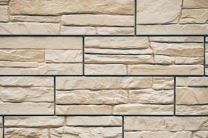 A stone texture with space to copy. Uneven tiles with protruding parts and cracks photo