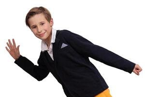Portrait of a boy who imitates walking on a white background. The student runs and looks at the camera and smiles. photo