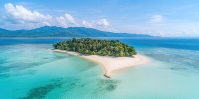 Tropical island with turquoise water and sandy beach under blue sky photo