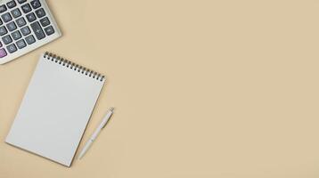 Notepad and calculator on a light background. Office tools. The concept of business and education. Copy space. Banner. photo