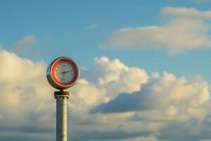 Old style analog clock showing almost noon time lapse with clouds passing by photo
