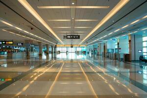 Empty airport terminal with shiny floor reflecting lights photo