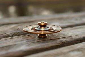 Modern spinning top resting on rustic wooden table photo