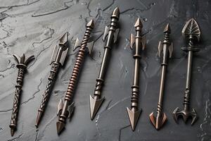 Seven different types of arrows lying on dark grey surface photo