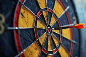 Red dart hitting the center of a yellow and black dartboard photo