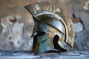 Ancient greek helmet standing on a stone ledge with blurred background photo