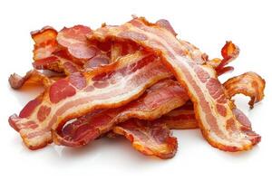 Delicious crispy bacon rashers piled up on white background photo