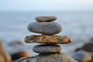 Stack of zen stones balancing on top of each other on beach photo