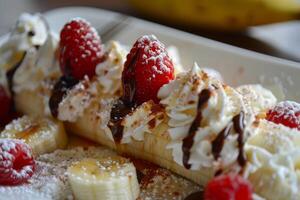 Banana split dessert indulging with raspberries chocolate sauce and whipped cream photo