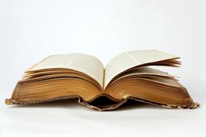 Open antique book lying on white background showing text and aged pages photo