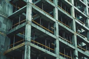 Building construction site showing concrete frame and metal supports photo