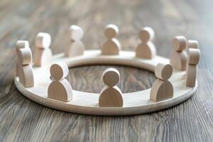 Wooden figures forming a circle on a wooden surface representing a business meeting photo