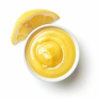 Lemon curd in a bowl with a lemon slice on white background photo