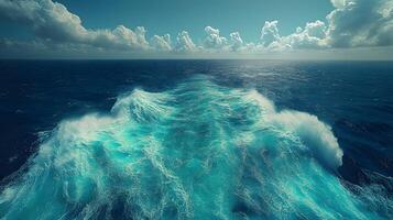 Ocean wake pattern stretches behind cruise ship in aerial view. Deep blue sea meets bright sky with white clouds, while turquoise foam trails create dynamic water movement on sunny day. sky photo