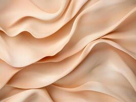 Abstract background of peach colored fabric with soft waves and folds photo