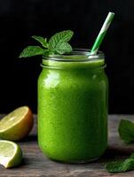 Refreshing green smoothie in a mason jar with lime and mint photo