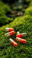 Red and orange capsules on the grass photo