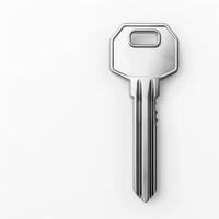 Silver key resting on white background symbolizing security and access photo