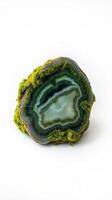 A piece of green and blue agate on a white surface photo