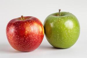 Red apple and green apple resting on white background photo
