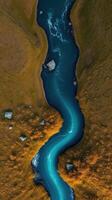 An aerial view of a river flowing through a field photo