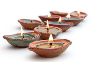 Burning oil lamps creating a warm, atmospheric glow on white background photo
