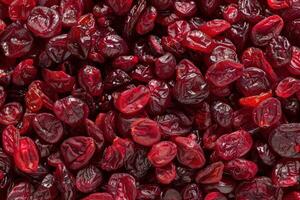Dried cranberries filling the frame creating a vibrant red photo