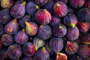 Fresh figs forming a colorful and textured background with one cut open photo
