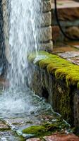 A water fountain spraying water on a stone wall photo