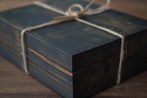 Elegant dark wooden keepsake box tied with string on table photo