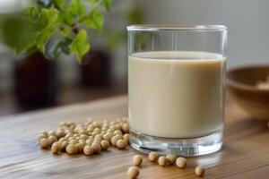 Glass of soy milk with soybeans on wooden table promoting healthy vegan lifestyle photo