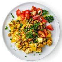 Delicious vegan tofu scramble with vegetables and herbs enjoying a healthy meal photo