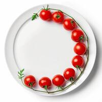 Fresh cherry tomatoes forming a crescent shape on a white plate photo