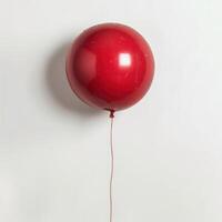 Red balloon floating on white background representing simplicity and minimalism photo