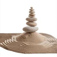 Stack of zen stones standing on raked sand creating a peaceful and relaxing atmosphere photo