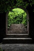 Stone steps leading to an archway overgrown with lush greenery photo