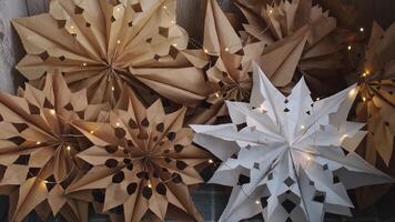 Before and after craft bags transform into 3d snowflakes with garland lights. Master class of making craft paper snowflakes for conscientious Christmas decor. Sustainable celebration minimal responsible DIY holiday project. Step by step instruction video