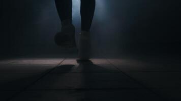 Close-up of jumping rope in a dark room with a back light in front, slow motion video