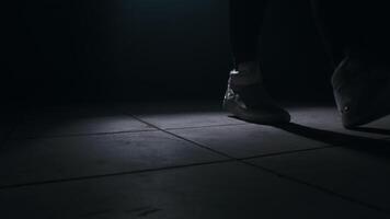 Close-up of jumping rope in a dark room with smoke with back light from the front, slow motion video