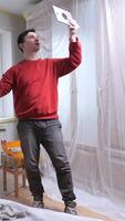 vertical blogger Handyman planning renovation project using tablet in empty room. Diy video